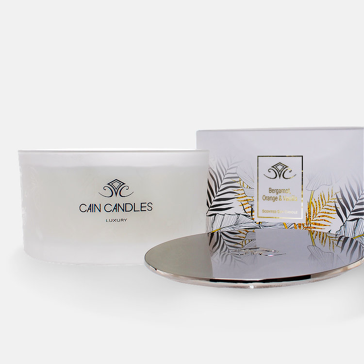 substantial luxury multi-wick container candle with heavy cast polished metal lid and gorgeous gold foiled leaf design presentation packaging