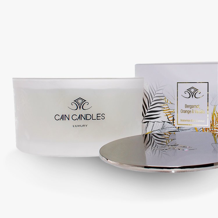 substantial luxury multi-wick container candle with heavy cast polished metal lid and gorgeous gold foiled leaf design presentation packaging